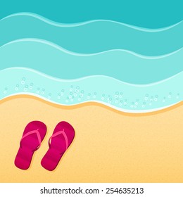 Flip-flops on the sand beach with the sea in the background. Vacation travel concept.