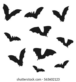 Flock of bats. Black shadows of bats on a white background. Vector illustration.