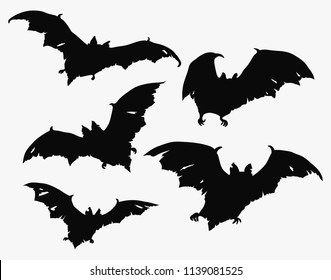 Flock of bats. Set of black silhouettes of bats with torn wings. Collection of bat zombies. Illustration of monsters for the Halloween. Drawing of night creatures. Flying demons. Tattoo.