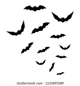 Flock of flying bats. Vector illustration. Silhouettes of  bats