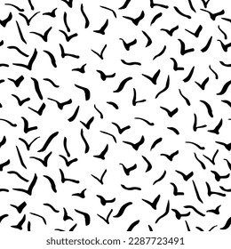 
A flock of flying birds isolated on a white background. Vector. Handwritten doodles.