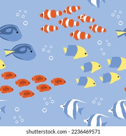 Flocks of bright exotic cartoon fish, seamless vector pattern