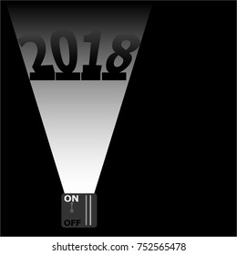 The floodlight illuminating the numbers 2018 in the dark.