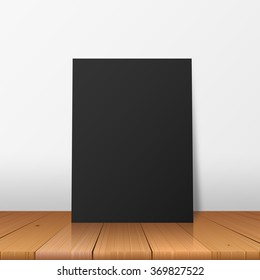 Floor standing poster sample for design portfolio presentation. Peace of black paper on the wooden floor vector illustration