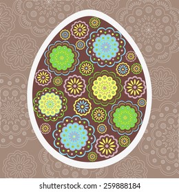 Floral colorful easter egg on brown background