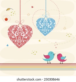 Floral decorated hanging hearts with cute love bird couple for Happy Valentines Day celebration on decorated background.