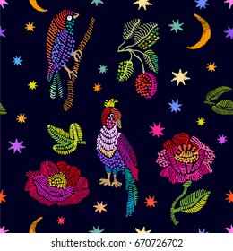 Floral embroidery with crescent moon and stars. Seamless vector pattern with birds, berries and flowers. Vintage motifs. Retro textile design collection. Colorful on dark.