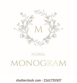 Floral monogram frame. Hand drawn wreath of wildflowers. Graphic element for wedding invitations, business sign, cafes.