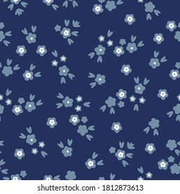 Floral pattern. Beautiful flowers on a dark blue background. Print with small blue flowers. Seamless vector texture. Elegant print for Wallpaper.