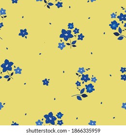 Floral pattern. Beautiful flowers on a yellow background. Print with small and large blue flowers. Print a color in a flower. Seamless vector texture. Spring bouquet.