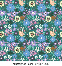 Floral pattern of blue, light yellow and purple flowers on a green background in cool tones. Rustic chic.