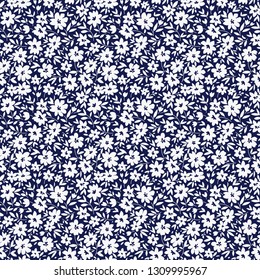 Floral pattern. Pretty flowers on dark blue background. Printing with small white flowers. Ditsy print. Seamless vector texture. Spring bouquet.