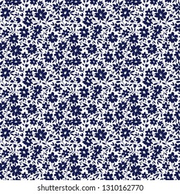 Floral pattern. Pretty flowers on white background. Printing with small navy blue flowers. Ditsy print. Seamless vector texture. Spring bouquet.