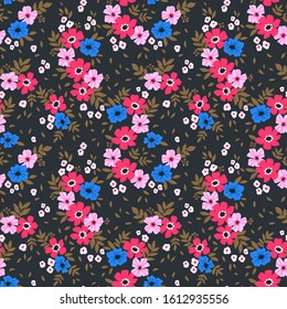 Floral pattern. Pretty flowers on dark background. Printing with small purple, pink and blue flowers. Ditsy print. Seamless vector texture. Spring bouquet.