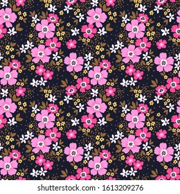 Floral pattern. Pretty flowers on dark violet background. Printing with small purple flowers. Ditsy print. Seamless vector texture. Spring bouquet.