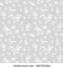 Floral pattern. Pretty flowers on light gray background. Printing with small white flowers. Ditsy print. Seamless vector texture. Spring bouquet. Stock vector.