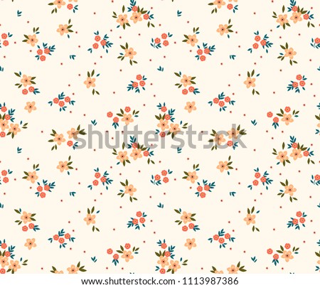 Floral pattern. Pretty flowers on white background. Printing with small light orange flowers. Ditsy print. Seamless vector texture. Spring bouquet.