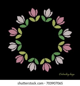 Floral round frame. Embroidered tulips on the dark contrast background..