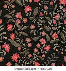 Floral seamless pattern. Colorful flowers on the dark backdrop. The effect of embroidery on denim