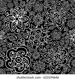 Floral seamless pattern with doodle flowers and leaves. Vector hand drawn pattern in black and white. Seamless pattern can be used for wallpapers, web page backgrounds, coloring book page. 