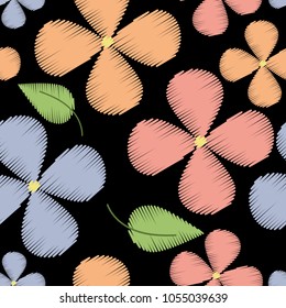 floral seamless pattern with pink, orange and blue flowers on a black background