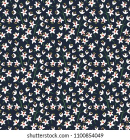 Floral seamless pattern with small flowers in vintage style. Surface design of white flowers on a dark blue background. A bouquet of spring flowers for fashion prints. Modern floral background.