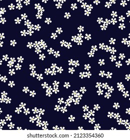 Floral seamless pattern with small white daisy flowers on dark blue background. Ditsy print. Cute plain chamomile florets design for trendy fabric, textile and wallpaper. Vector illustration