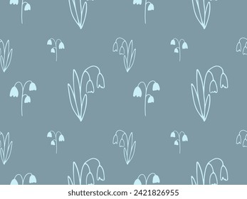 A floral seamless pattern of snowdrops. Cute hand drawn doodle silhouette bellflower on blue background. Spring botanical pattern for wallpaper, fabric, covers