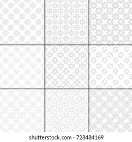 Floral seamless patterns. Set of gray and white colored backgrounds with flower elements for fabrics and wallpapers
