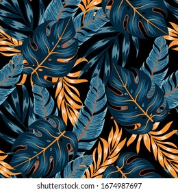 Floral seamless tropical pattern with bright yellow and blue plants and leaves on a dark background. Jungle leaf seamless vector floral pattern background. Seamless exotic pattern with tropical plants