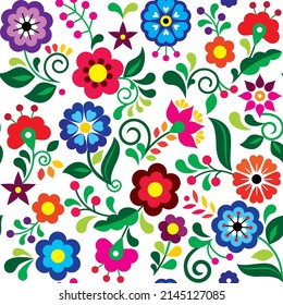 Floral seamless vector pattern inspired by traditional folk art embroidery designs from Mexico - textile or farbic print ornament. Retro wallpaper with flowers, leaves and swirls