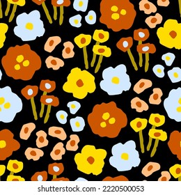 Floral vector seamless pattern. Bright flowers in autumn yellow-orange colors on a black background. For printed fabrics, textiles, boho decor.
