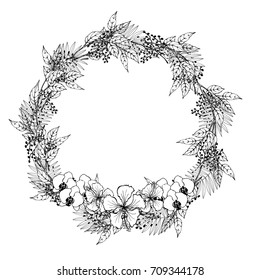 Floral wedding wreath with black and white orchids and leaves. 