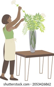 florist girl puts flowers in a vase