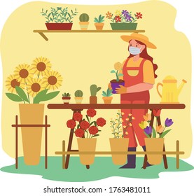 Florist is taking care the flowers while keep using medical mask