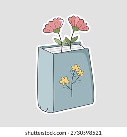 Flower book sticker featuring a blue journal with pink blossoms growing inside. Perfect for reading journals, book club branding, and "dark academia" aesthetics