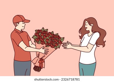 Flower delivery man hands bouquet to woman delighted with unexpected valentine day gift from boyfriend. Courier hands bouquet of red roses to happy client, to advertise services of flower shop