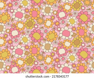 Flower heads in different sizes, graphic daisies in orange, pink, brown, colors from the 1960's and 1970's. In a seamless vector repeat.