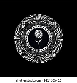 flower icon inside chalk emblem written on a blackboard