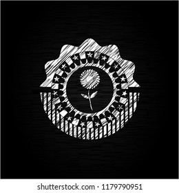 flower icon inside chalkboard emblem written on a blackboard