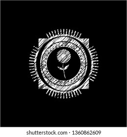 flower icon inside chalkboard emblem written on a blackboard