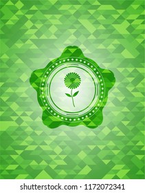 flower icon inside green emblem. Mosaic background