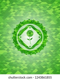 flower icon inside green mosaic emblem