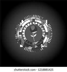 flower icon inside grey camouflaged emblem