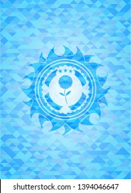 flower icon inside light blue mosaic emblem