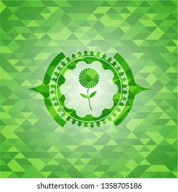 flower icon inside realistic green emblem. Mosaic background