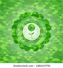 flower icon inside realistic green emblem. Mosaic background