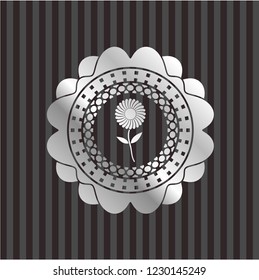 flower icon inside silvery emblem or badge