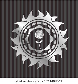 flower icon inside silvery emblem