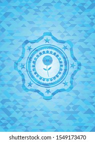 flower icon inside sky blue mosaic emblem